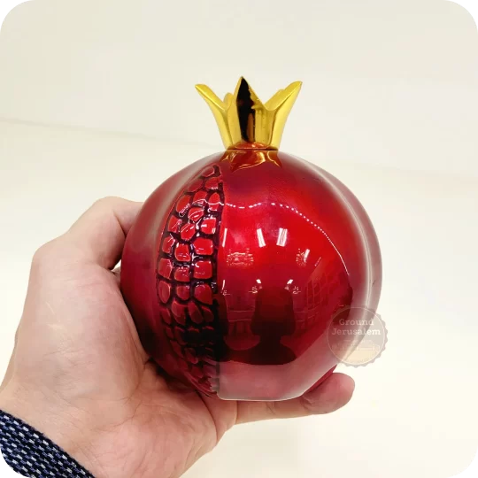 Red pomegranate figurine from Israel with golden crown